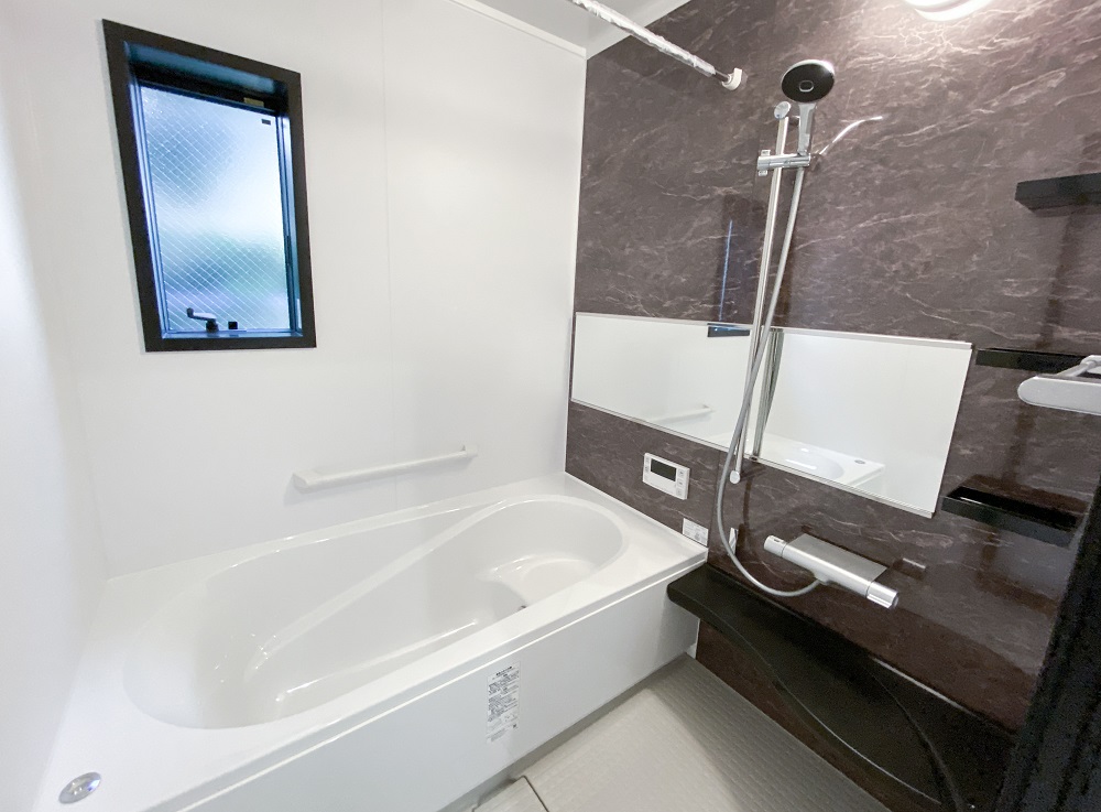 洗面室と浴室はモノトーンで統一されていて、シンプルながらもこだわりを感じる空間となっています。グレーの洗面カウンターや壁いっぱいのワイドミラーも洗練された印象を与えてくれます。
